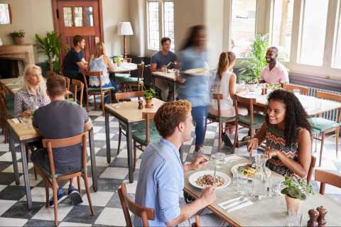Customers Enjoying Meals Busy Restaurant